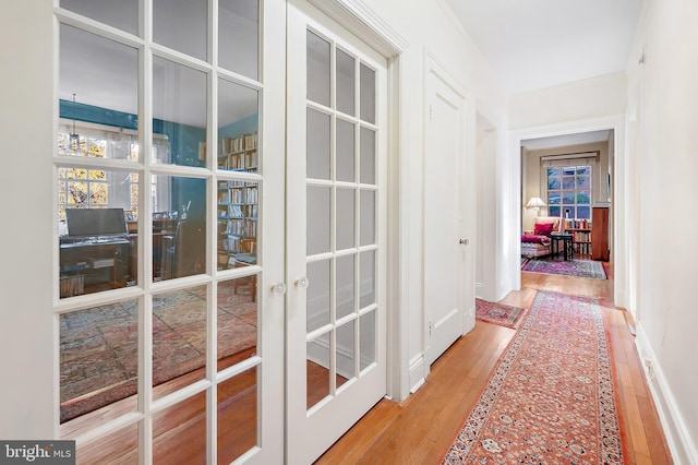 doorway with light wood-type flooring and french doors