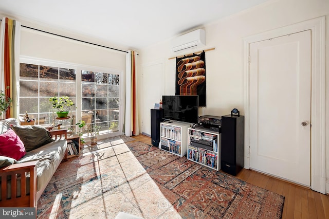 living room featuring light hardwood / wood-style floors and a wall mounted AC