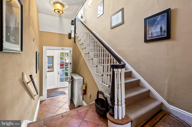 stairway featuring tile patterned flooring