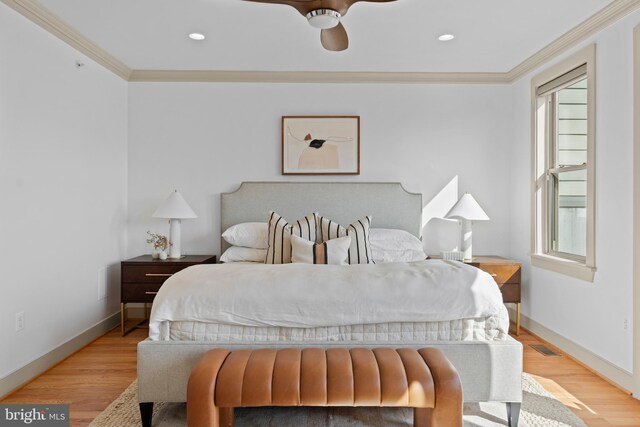 bedroom featuring recessed lighting, crown molding, baseboards, and wood finished floors