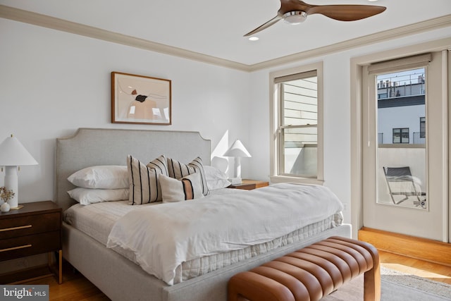 bedroom with ceiling fan, wood finished floors, and crown molding