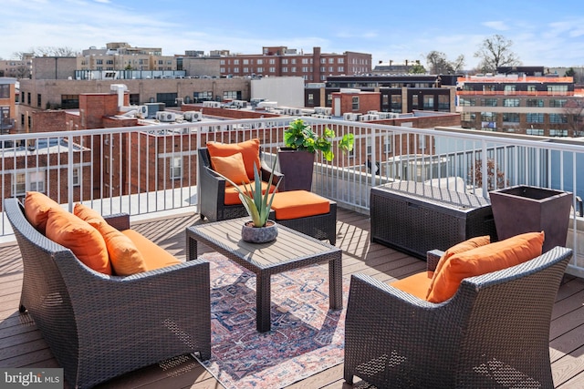 wooden terrace featuring an outdoor hangout area and a view of city