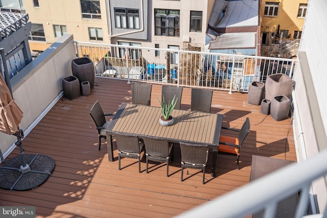 wooden terrace featuring outdoor dining space