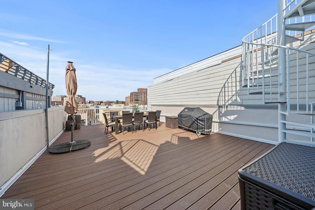 deck featuring a grill and outdoor dining space