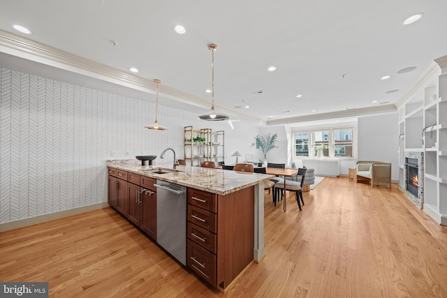 kitchen with wallpapered walls, dishwasher, a peninsula, a glass covered fireplace, and a sink