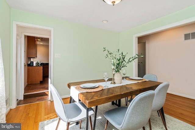 dining room with light wood-style flooring, recessed lighting, baseboards, and visible vents