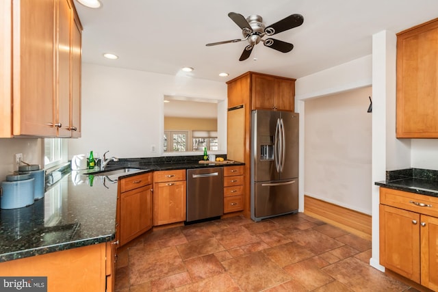 kitchen with a healthy amount of sunlight, brown cabinets, appliances with stainless steel finishes, and a sink