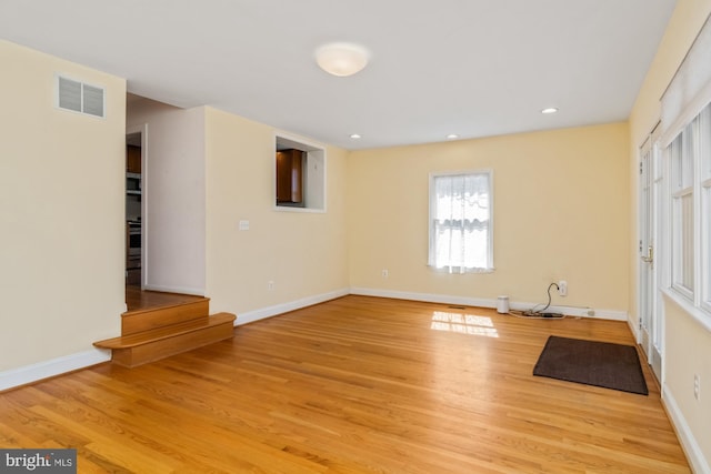 interior space featuring visible vents, recessed lighting, baseboards, and wood finished floors