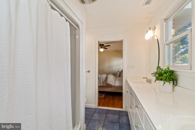 full bath with tile patterned flooring, visible vents, connected bathroom, double vanity, and a sink