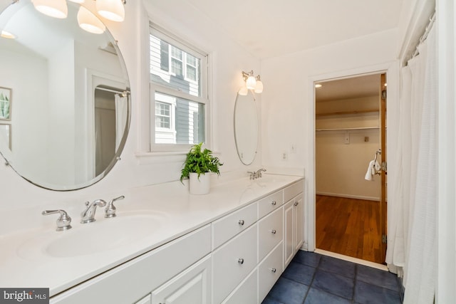 bathroom with double vanity, tile patterned flooring, and a sink