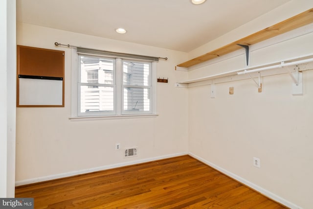 interior space with wood finished floors and visible vents