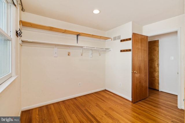 spacious closet with wood finished floors and visible vents