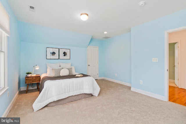 carpeted bedroom with visible vents and baseboards