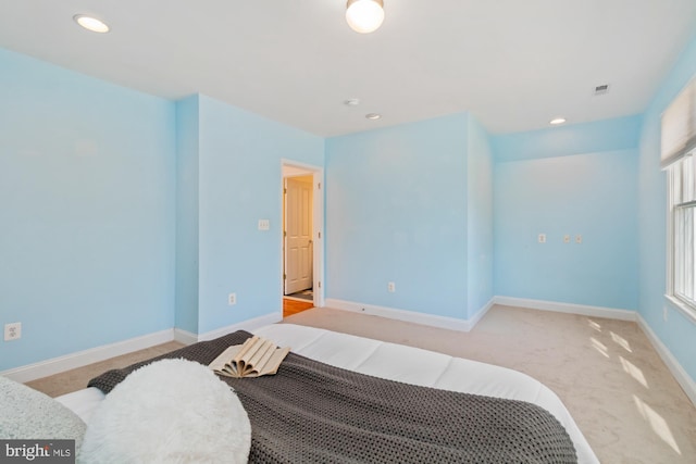 carpeted bedroom with recessed lighting, visible vents, and baseboards