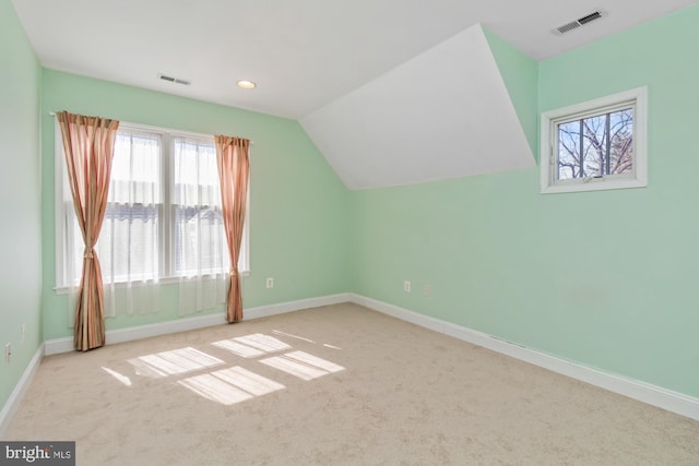 additional living space featuring visible vents, baseboards, and vaulted ceiling