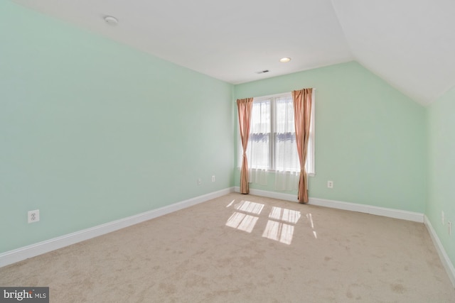 bonus room featuring baseboards, light carpet, and vaulted ceiling