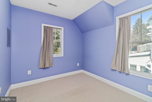 interior space featuring carpet, vaulted ceiling, baseboards, and visible vents