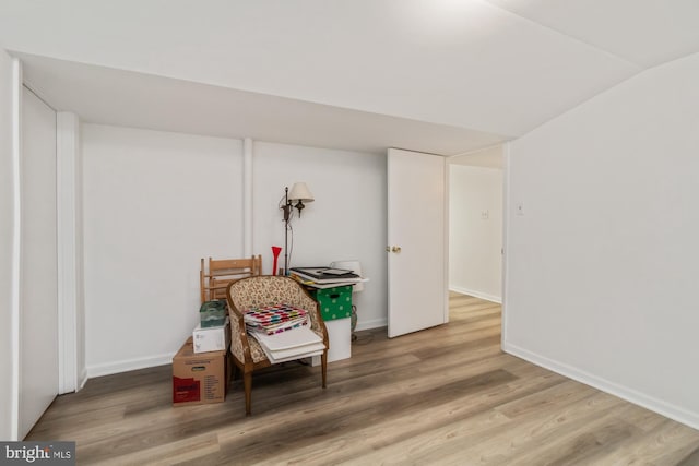 recreation room featuring vaulted ceiling, wood finished floors, and baseboards