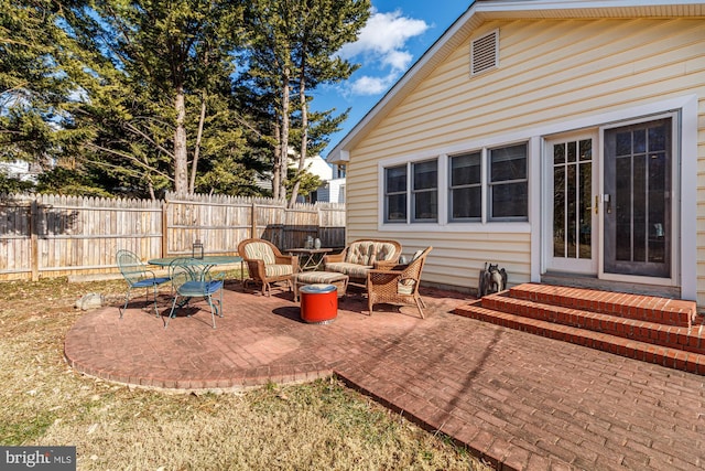 view of patio / terrace with entry steps, an outdoor living space, and fence