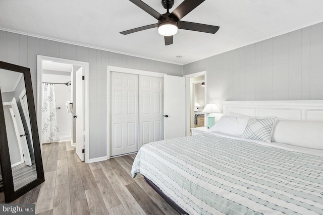 bedroom featuring ceiling fan, ornamental molding, a closet, and light hardwood / wood-style flooring