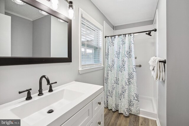 bathroom featuring vanity, hardwood / wood-style floors, crown molding, and a shower with shower curtain