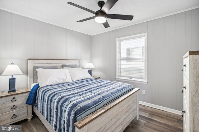 bedroom with crown molding, dark wood-type flooring, and ceiling fan