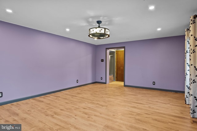 spare room with light hardwood / wood-style flooring