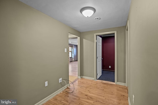 corridor featuring light hardwood / wood-style floors