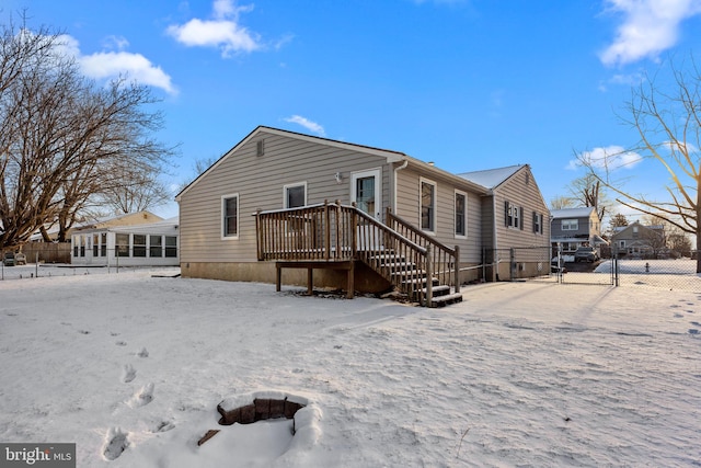 snow covered property with a deck