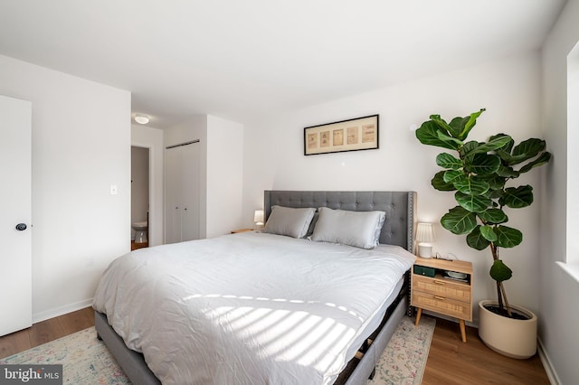 bedroom featuring hardwood / wood-style flooring and a closet