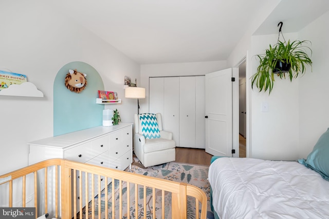 bedroom with hardwood / wood-style flooring and a closet