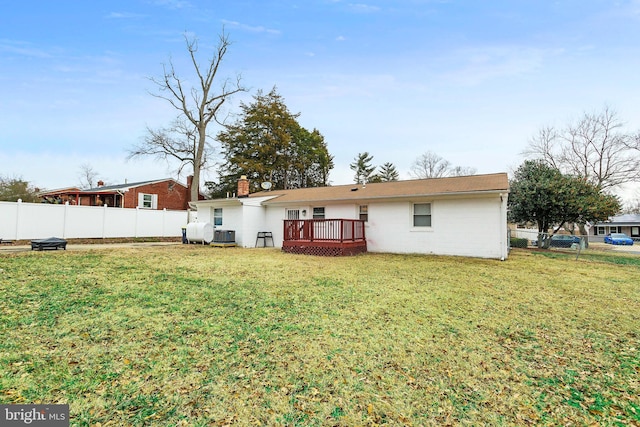 back of house with central AC unit, a yard, and a deck