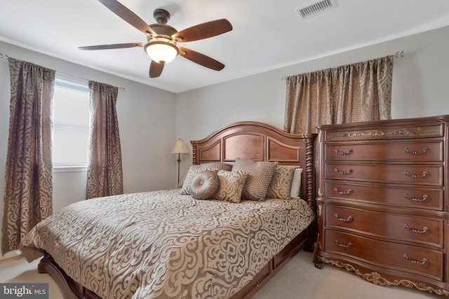 bedroom featuring light colored carpet and ceiling fan