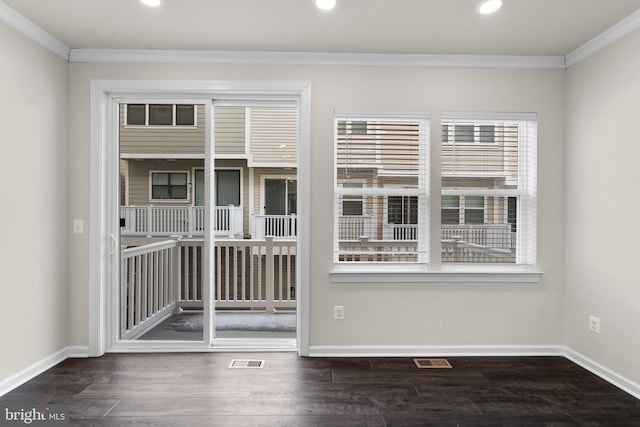 spare room featuring dark wood-type flooring and ornamental molding