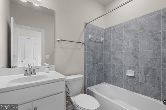 full bathroom with tiled shower / bath combo, vanity, and toilet