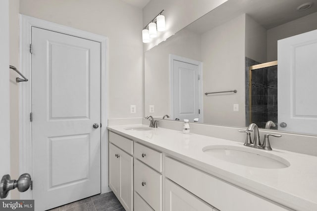 bathroom featuring tile patterned flooring, vanity, and a shower with door