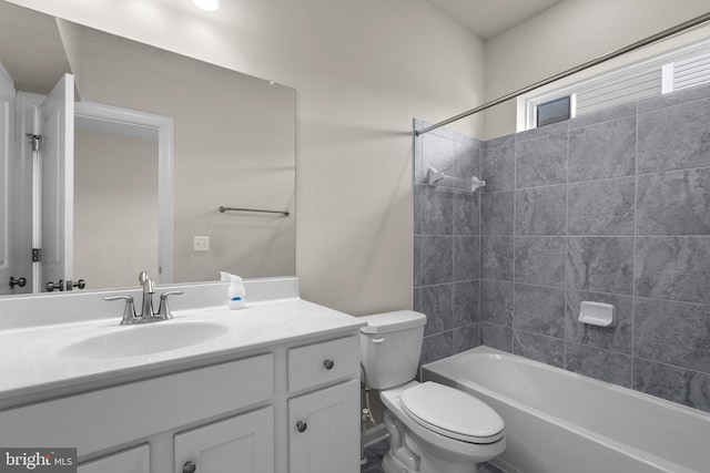 full bathroom with tiled shower / bath combo, vanity, and toilet