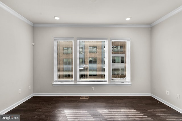 spare room with crown molding and dark wood-type flooring