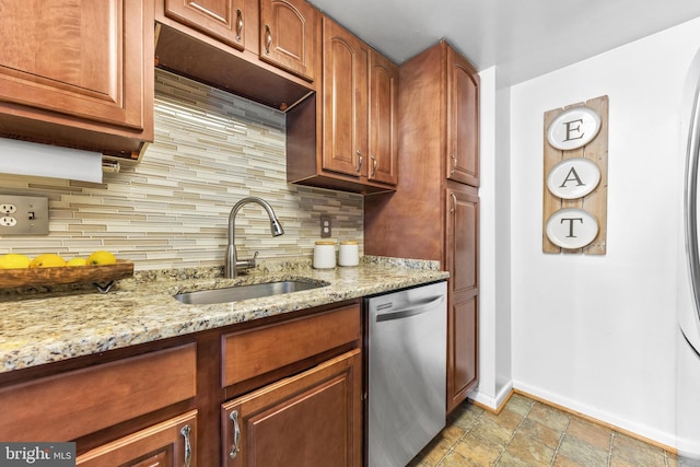 kitchen with dishwasher, sink, light stone counters, and decorative backsplash