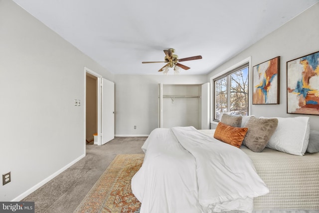 carpeted bedroom featuring ceiling fan and a closet