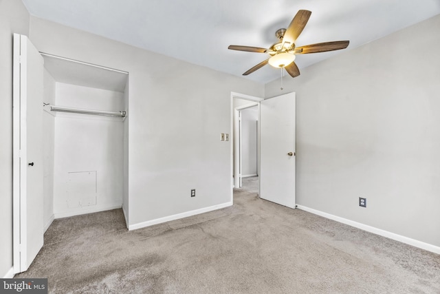 unfurnished bedroom featuring light colored carpet, a closet, and ceiling fan