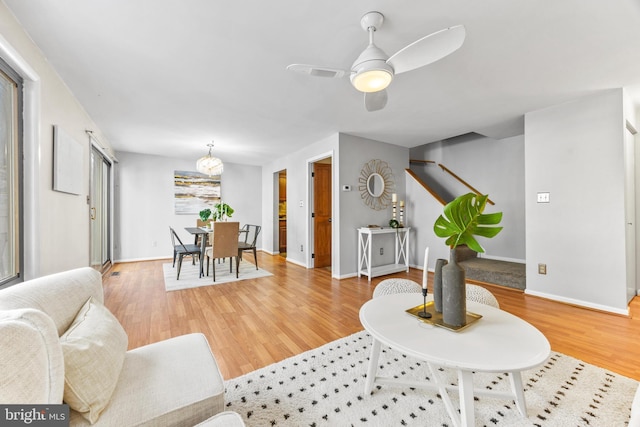 living room with hardwood / wood-style floors and ceiling fan