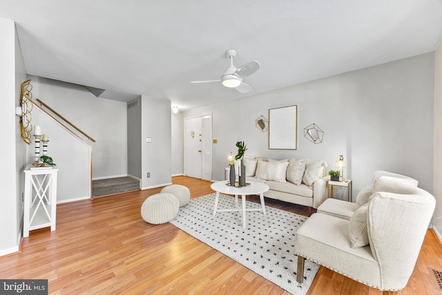 living room featuring hardwood / wood-style flooring and ceiling fan