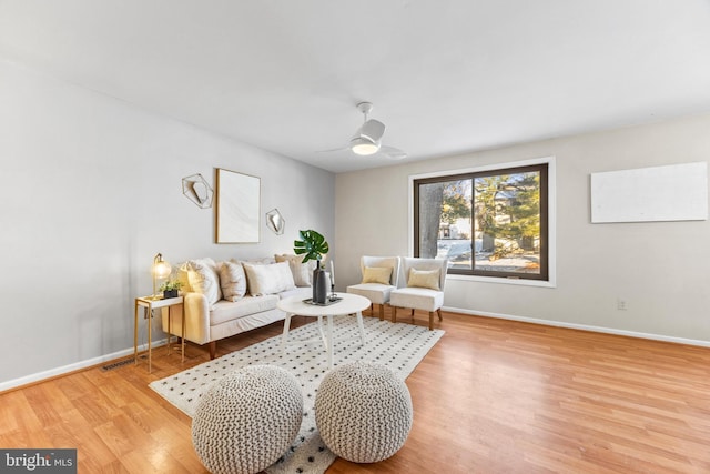 living room with ceiling fan and light hardwood / wood-style floors