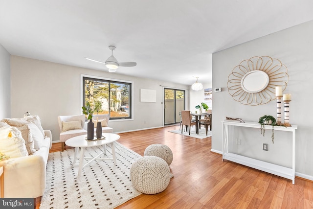 living room featuring ceiling fan and light hardwood / wood-style flooring