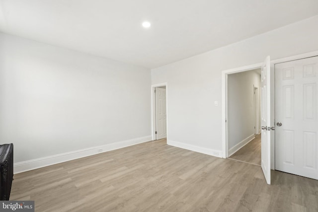 spare room featuring light hardwood / wood-style floors