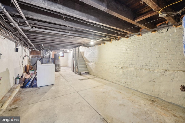 basement with gas water heater and washer / dryer