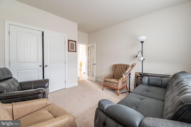 living room with french doors and light carpet