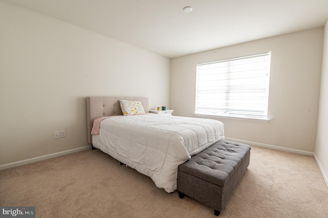 bedroom featuring light colored carpet