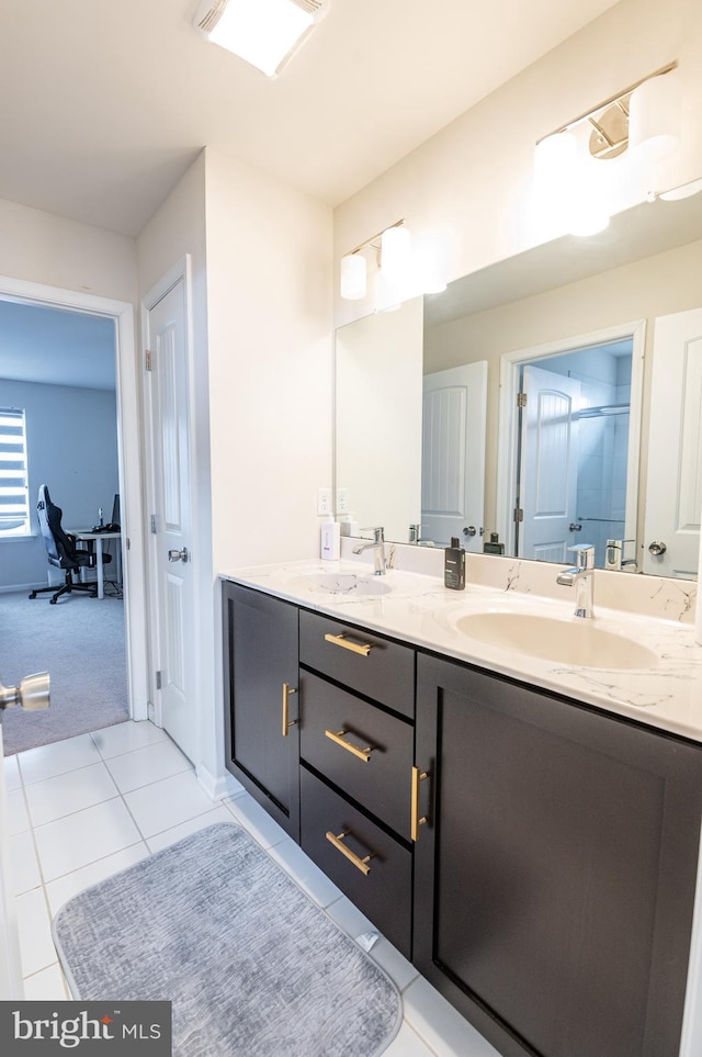 bathroom featuring tile patterned flooring, vanity, and a shower with door